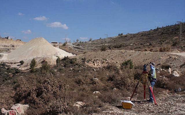 Surveyors take measurements of the road leading to the planned Palestinian city Rawabi in 2010 (photo credit: Issam Rimawi/Flash90)
