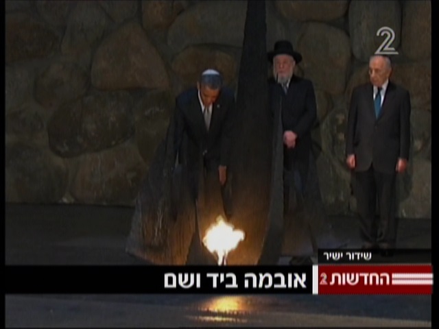 President Obama rekindles the 'eternal flame' at the Yad Vashem Holocaust Memorial Museum on Friday (photo credit: Channel 2 screenshot)