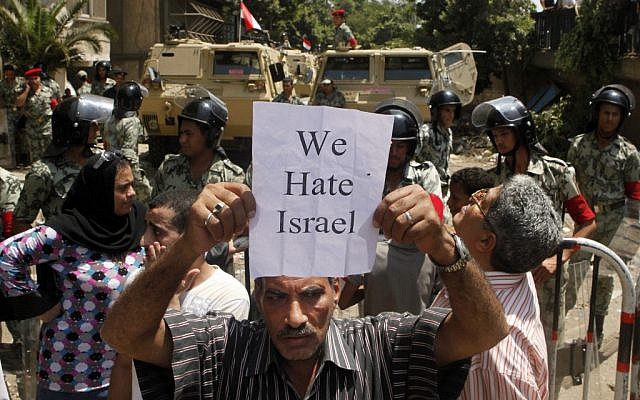 An Egyptian protester holds an anti-Israel slogan near the Israeli embassy in Cairo, Egypt, Sunday, Aug. 21, 2011. (AP Photo/Amr Nabil)