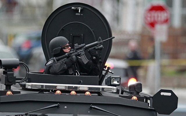 SWAT teams, bomb squads, and helicopters descend on Watertown, Massachusetts, which has remained on lockdown while officials try to locate the second Boston Marathon bomber, suspected to be Dzhokhar Tsarnaev. (photo credit: AP)