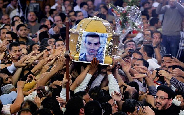 Egyptian Christians carry the coffin of Morqos Kamal, at the Saint Mark Coptic cathedral in Cairo, Egypt, Sunday, April 7, 2013. (photo credit: AP/Amr Nabil)