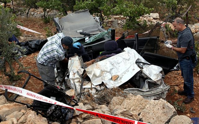 Rescue personnel at the scene where Asher Palmer and his son were killed by rocks thrown at their vehicle on Route 60 near Kiryat Arba in the West Bank on Friday, September 23, 2011. (photo credit: Yossi Zamir/Flash 90)