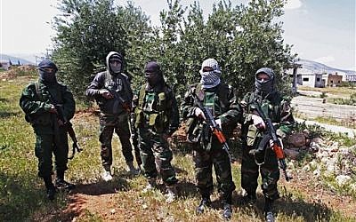 Lebanese pro-Syrian Popular Committees fighters near the northeastern Lebanese town of al-Qasr, Lebanon.(photo credit: AP Photo/Bilal Hussein)