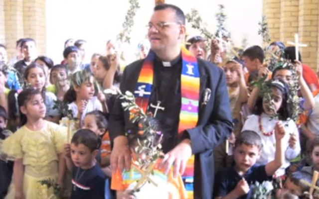 Canon Andrew White at St. George's Church, Baghdad, with children from his congregation (screenshot: YouTube)