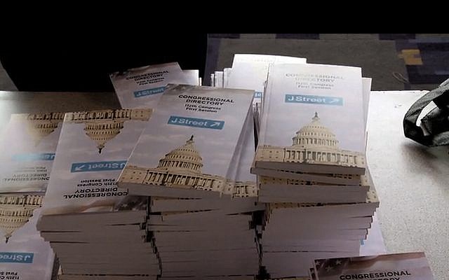 People pick up J street lobbying material during a conference in Washington DC (image capture: J Street: The Documentary trailer)