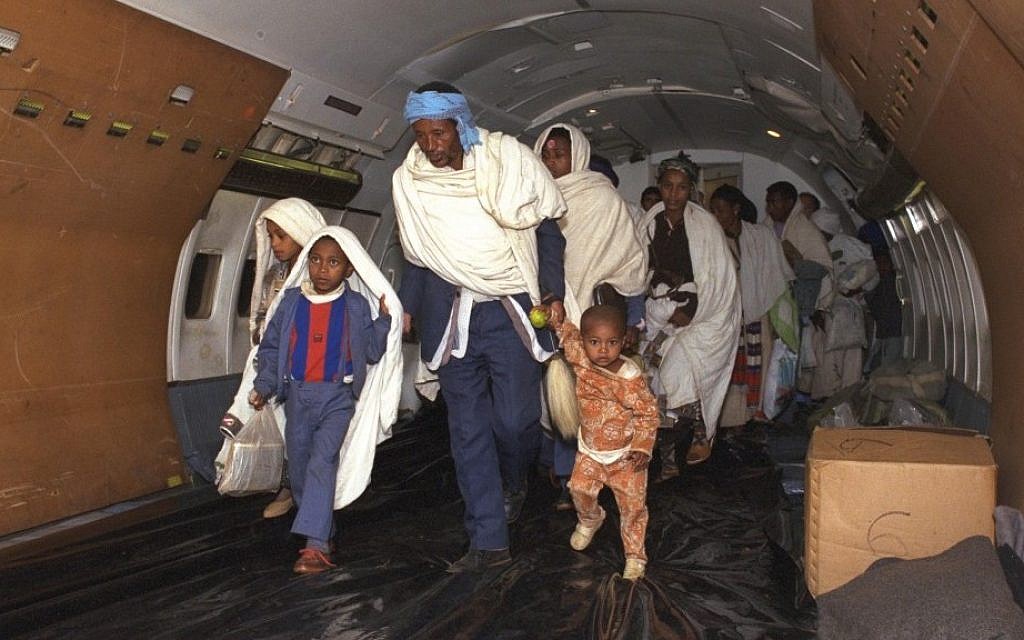 New Ethiopian immigrants boarding an aircraft en route from Addis Ababa to Israel during Operation Solomon, 1991. (Natan Alpert/GPO)