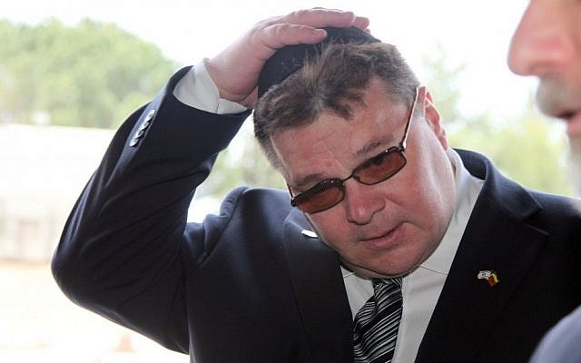 Linas Linkevicius, the foreign minister of Lithuania, puts on a yarmulke as he enters the Hall of Remembrances in the Yad Vashem Holocaust Memorial in Jerusalem on May 19, 2013. (photo credit: Isaac Harari/Flash90)