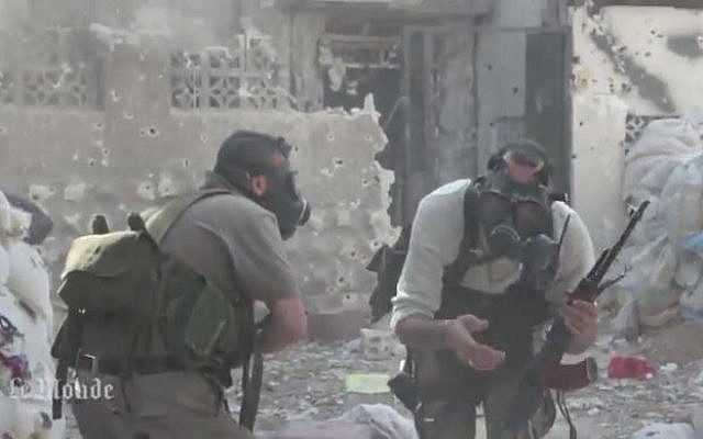 Syrian rebel fighters in gas masks against a chemical weapons attack, 2013. (screen capture: Youtube/MrMrAsi)