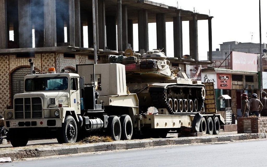 An Egyptian Army vehicle with a tank heads to the closed Rafah border crossing between Egypt and the Gaza strip, in Sheikh Zuweyid, northern Sinai, Egypt, Monday, May 20, 2013 (AP Photo/Roger Anis, El Shorouk Newspaper)