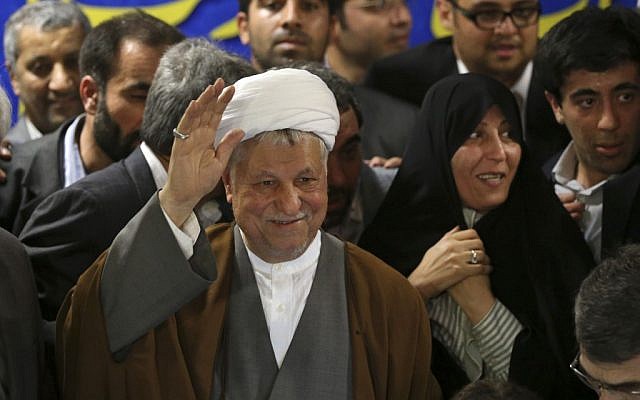 Former Iranian president Akbar Hashemi Rafsanjani waves as he registers his candidacy for the presidential election, May 11, 2013, before he was disqualified by the Guardian Council. (AP/Ebrahim Noroozi)