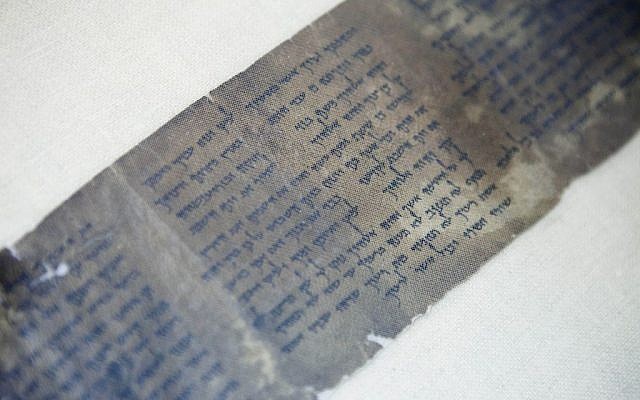 This photo shows the Ten Commandments written on one of the Dead Sea Scrolls in Jerusalem. (photo credit: AP/Dan Balilty)