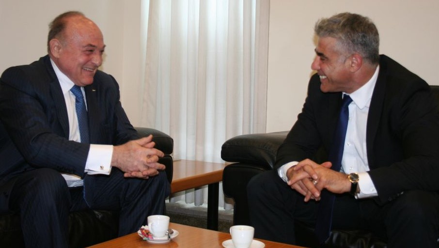 Israeli Finance Minister Yair Lapid, right, with Palestinian counterpart Shukri Bishara in Jerusalem, June 16, 2013 (photo credit: Anat Hamami/Finance Ministry)