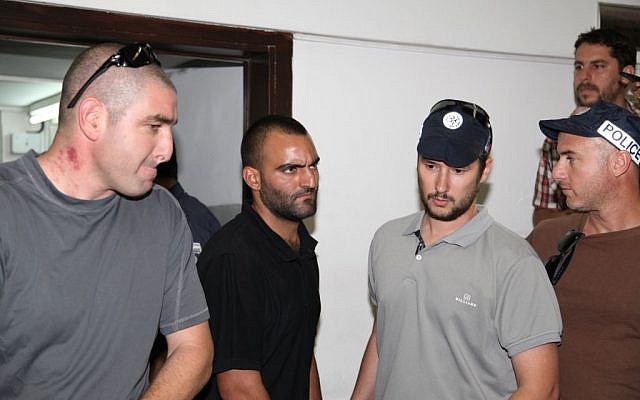 Hagai Felician (second from left), the prime suspect in the 2009 gay youth club shooting, at the Tel Aviv magistrate's court, on Thursday, June 6, 2013
