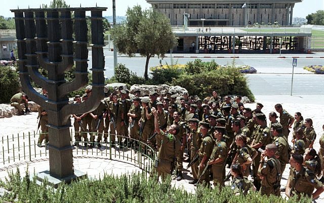 Israel soldiers gather around a large Menorah standing outside the Knesset in 2001. (photo credit: Nati Shohat/Flash90)