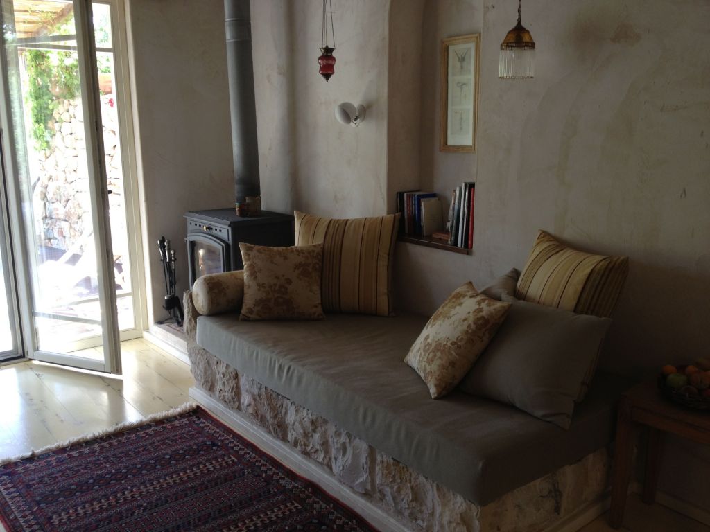 A view of the custom-built living room and cast iron stove (for the colder months) at Tamar v'Gefen (photo credit: Jessica Steinberg/Times of Israel)