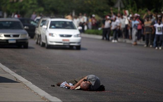 A man lies dead after being shot by Egyptian troops in Cairo, Egypt, Friday, July 5 (photo credit: AP/Khalil Hamra)