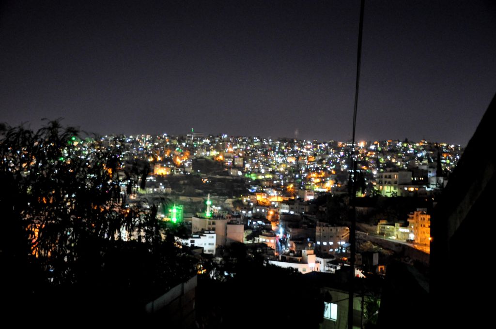 A view of the Amman skyline, dotted by the lights of minarets, at night (photo credit: Michal Shmulovich/Times of Israel)