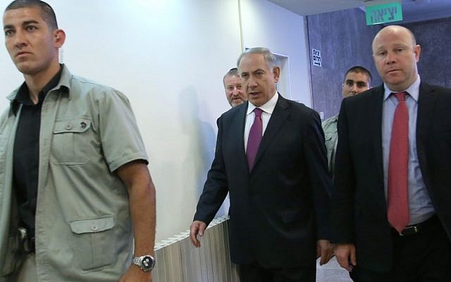Benjamin Netanyahu, center, walking to a cabinet meeting Sunday, with Gil Shefer at right. (photo credit: Miri Tzahi/ Pool/ Flash90)