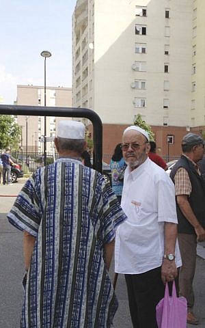 Muslim men shop in Trappes, southwest of Paris, Tuesday, July 23, 2013. (photo credit: AP/Elaine Ganley)