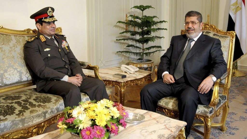 In this Thursday Feb, 21, 2013 file photo, released by the Egyptian Presidency, Egyptian Minister of Defense, Lt. Gen. Abdel-Fattah el-Sissi, left, meets with Egyptian President Mohammed Morsi at the presidential headquarters in Cairo, Egypt (AP Photo/Mohammed Abd El Moaty, Egyptian Presidency, File)
