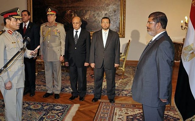 Egyptian President Mohammed Morsi swears in newly-appointed Minister of Defense, Lt. Gen. Abdel-Fattah al-Sisi, in Cairo, Egypt last August (photo credit: AP/Egyptian Presidency)
