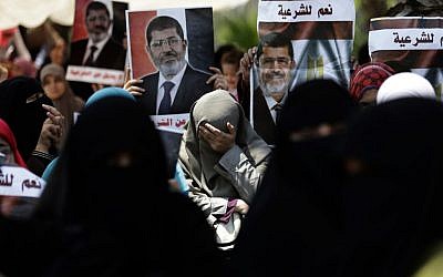 Supporters of ousted Egypt's President Mohammed Morsi chant slogans during a protest near the University of Cairo, Giza, Egypt, Friday, July 5 (photo credit: AP/Hassan Ammar)