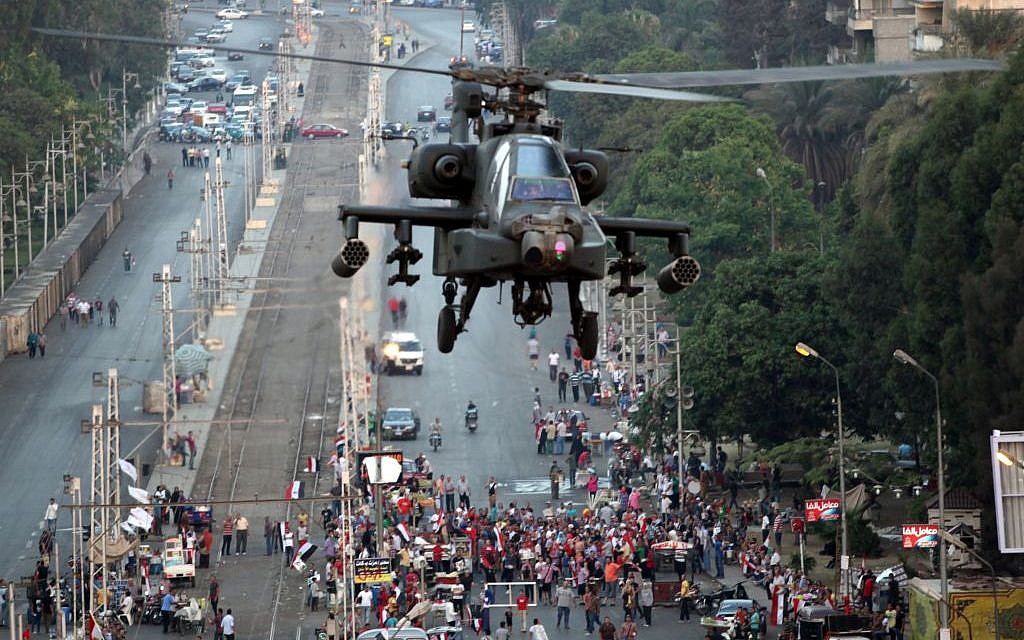 A military attack helicopter flies near the presidential palace in Cairo, Egypt, Friday, July 5 (photo credit: AP/Khalil Hamra)