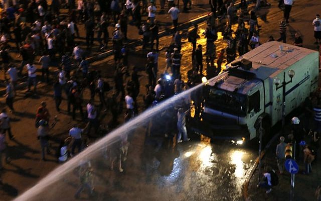 Water cannon sprays protesters during clashes in Istanbul, Turkey, Saturday, June 22, 2013. (photo credit: AP/Petr David Josek)