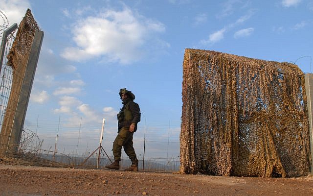 A soldier at the border fence between Israel and Lebanon (photo credit: Hamad Almakt/Flash 90)