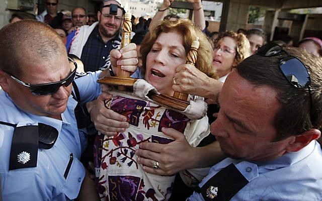 Police escort Anat Hoffman holding a Torah scroll from the Western Wall, on July 12, 2010. (photo credit: Miriam Alster/Flash90)
