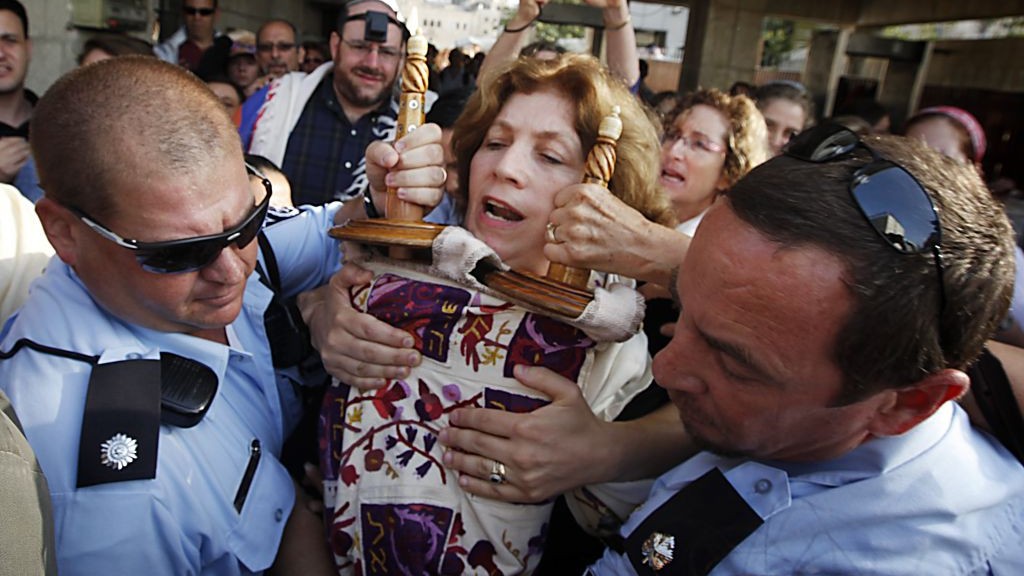 Police escort Anat Hoffman holding a Torah scroll from the Western Wall, on July 12, 2010. (photo credit: Miriam Alster/Flash90)