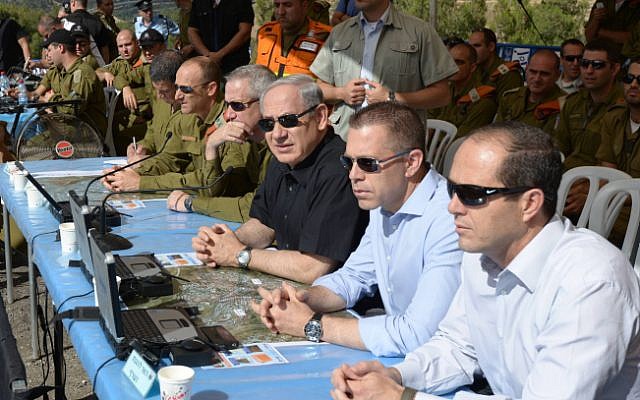 File: Prime Minister Benjamin Netanyahu, in the middle in black, flanked by then-home front defense Minister Gilad Erdan, in blue, and then-IDF Chief of Staff Lt. Gen. Benny Gantz and Maj. Gen. Eyal Eisenberg in May 2013. (Amos Ben Gershom/GPO/Flash90)