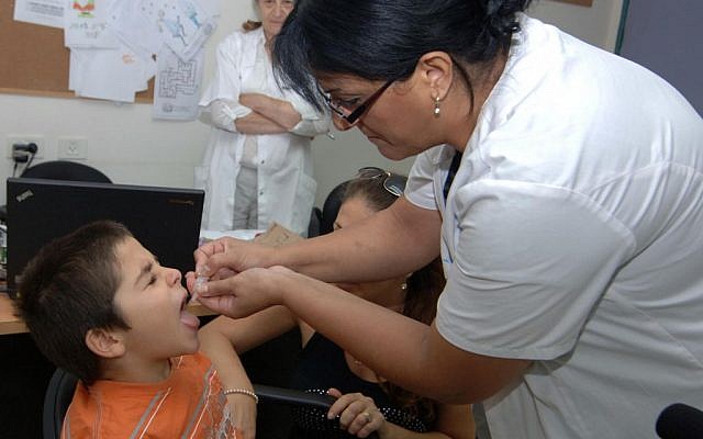 Illustrative: A child receives the polio vaccine at the Health Ministry office in Beersheba on August 5, 2013. (Dudu Greenspan/Flash90)