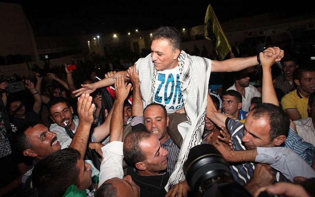 A released Palestinian prisoner is welcomed as he arrives at the Palestinian Authority headquarters in the West Bank city of Ramallah, August 2013 (photo credit: Issam Rimawi/Flash90)