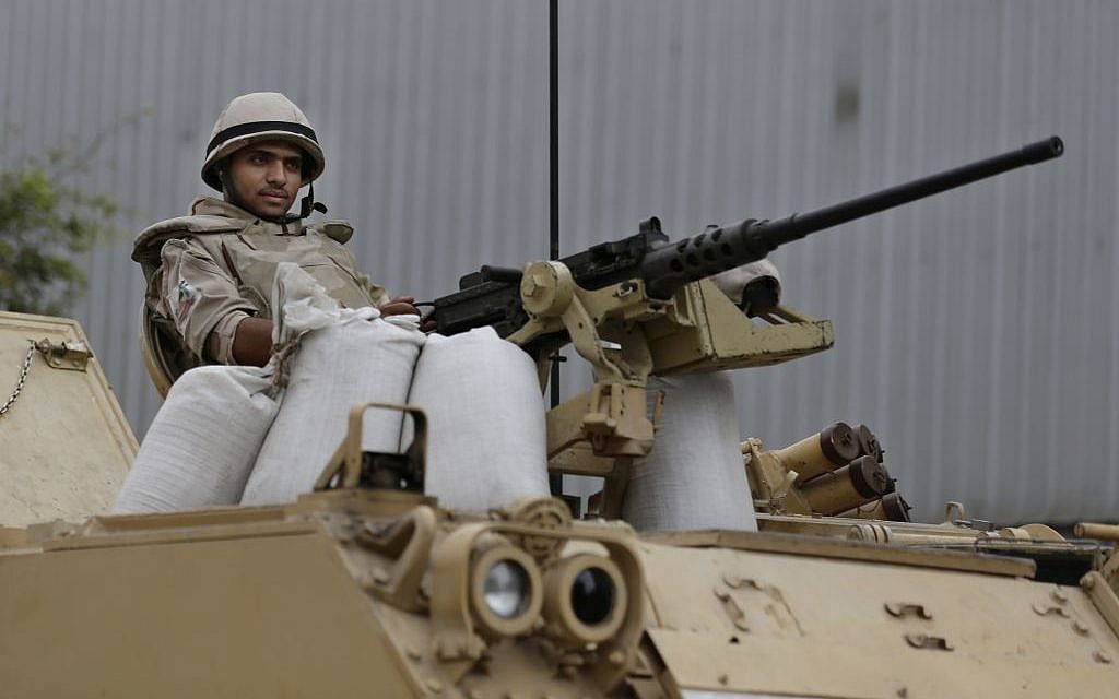 An Egyptian army soldier takes his position on top of an armored vehicle while guarding an entrance to Tahrir Square in Cairo on Friday, August 16. (photo credit: AP/Hassan Ammar)