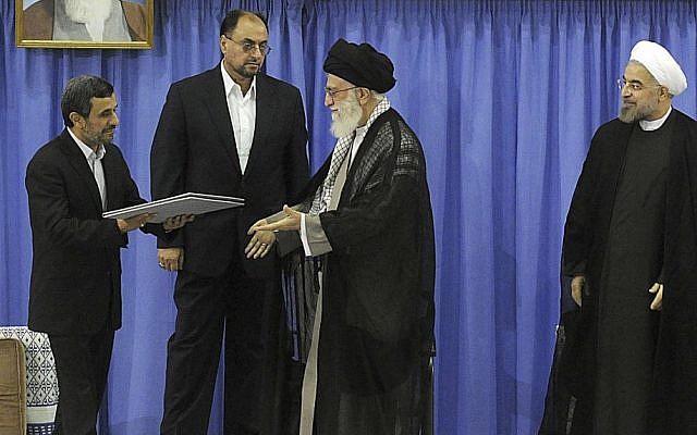 Outgoing president Mahmoud Ahmadinejad, left, delivers the official seal of approval of Supreme Leader Ayatollah Ali Khamenei, center, to give to President Hassan Rouhani, right, in an official endorsement ceremony, in Tehran, Iran, August 3, 2013. (photo credit: AP/Office of the Iranian Supreme Leader)