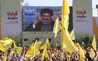 Hezbollah chief Hassan Nasrallah addressing supporters via satellite link during a rally in the southern Lebanese border village of Aita in August 2013. (photo credit: AP/Mohammed Zaatari)