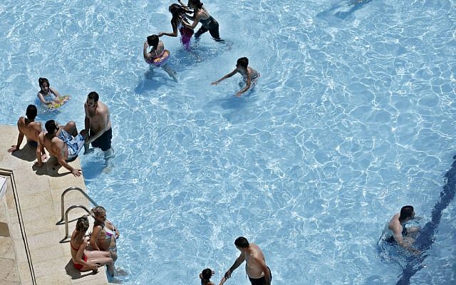 Syrians sunbathe and swim at a pool in Damascus, Syria, Friday, Aug. 23, 2013. (photo credit: AP/Hassan Ammar)
