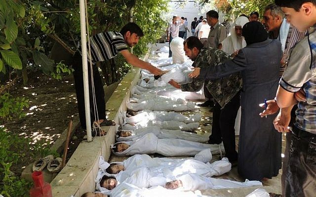 Syrian citizens try to identify dead bodies after an alleged poisonous gas attack near Damascus, on August 21, 2013 (photo credit: AP/Local Committee of Arbeen)