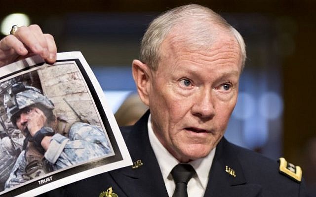 Gen. Martin Dempsey, chairman of the Joint Chiefs of Staff, holds up a photo of a deployed American soldier as he testifies before the Senate Armed Services Committee at his reappointment hearing, on Capitol Hill in Washington. July 18, 2013. (photo credit: AP/J. Scott Applewhite)