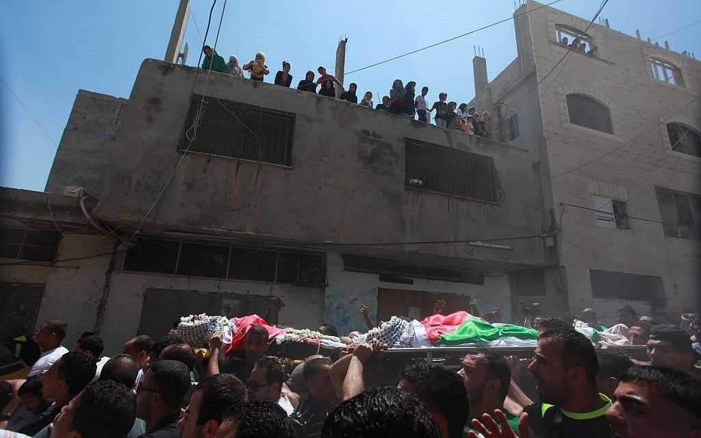 Hundreds attend the funeral of three Palestinian men shot dead by Israeli troops in the Qalandiya refugee camp in the West Bank, Monday, August 26, 2013 (photo credit: Issam Rimawi/Flash90)