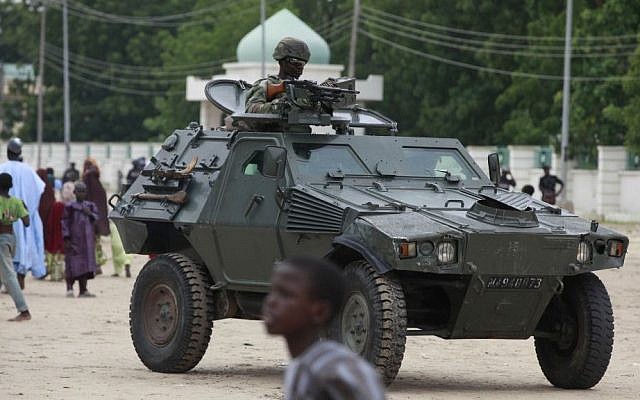 Illutrative photo of Nigerian soldiers in an armored vehicle following a terrorist attack, August 2013 (photo credit: AP/Sunday Alamba/File)