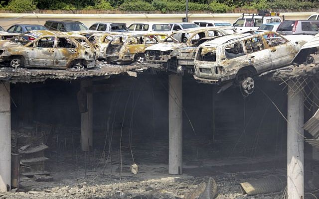 This photo released by the Kenya Presidency shows the collapsed upper car park of the Westgate Mall in Nairobi, Kenya Thursday, September 26, 2013. Working near bodies crushed by rubble in a bullet-scarred, scorched mall, FBI agents continued fingerprint, DNA and ballistic analysis to help determine the identities and nationalities of victims and al-Shabab gunmen who attacked the shopping center, killing more than 60 people. (photo credit: AP Photo/Kenya Presidency)