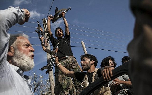 Syrian rebel fighters return from the battlefield in Idlib province, Syria, September 2013 (photo credit: AP)