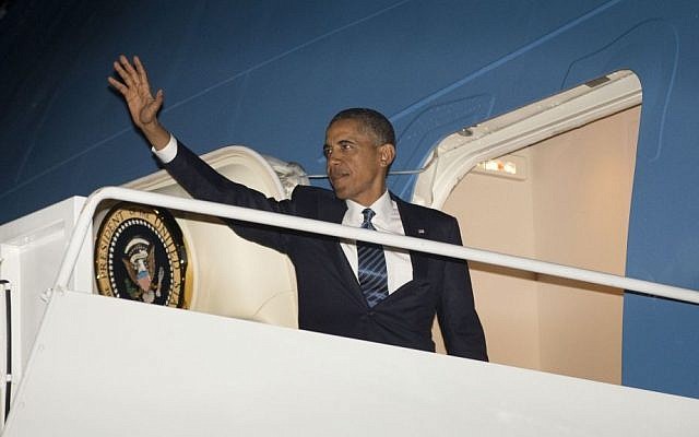 US President Barack Obama waves as he boards Air Force One before his departure on Tuesday to Sweden and Russia (photo credit: AP/Pablo Martinez Monsivais)