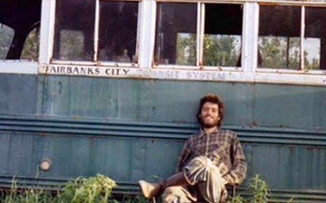Christopher McCandless outside Alaskan Bus 142 where his body was found. (photo credit: YouTube screenshot)