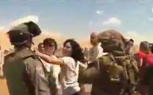 French diplomat Marion Fesneau-Castaing pushing an IDF soldier during the September incident. (Screenshot/YouTube)