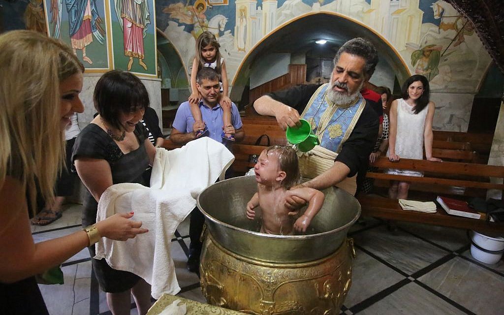 A Christian child is baptized in Nazareth's Greek Orthodox Church of the Annunciation, August 2013. (photo credit: Yossi Zamir/Flash90)