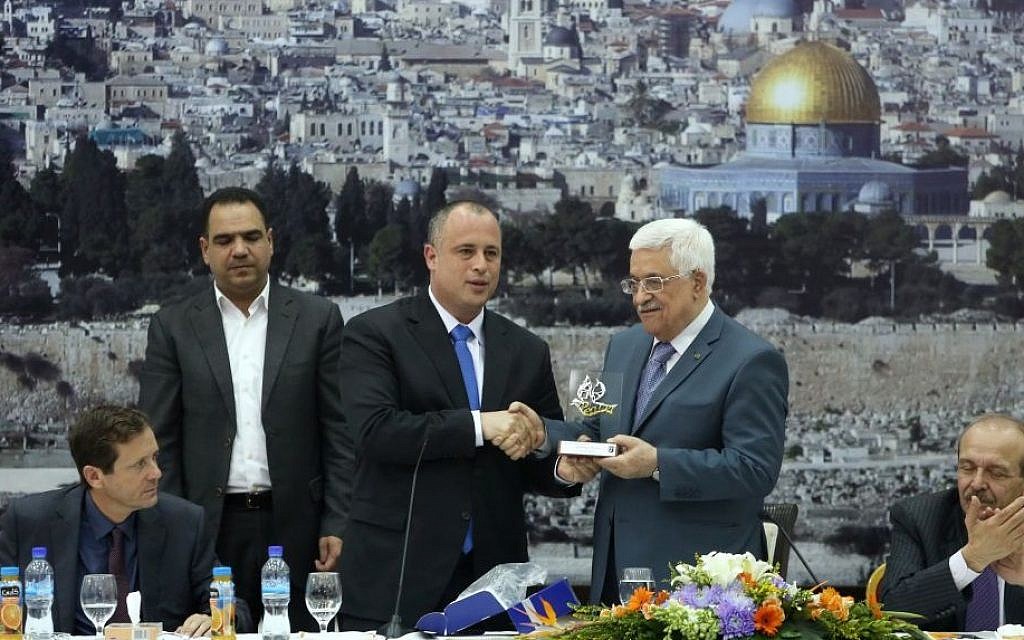 Labor MK Hilik Bar (center) with Palestinian Authority President Mahmoud Abbas during a meeting between Palestinian politicians and Israeli MKs in Ramallah, October 07, 2013. Isaac Herzog, elected Labor leader in November 2013, is seated at left. (photo credit: Flash90)