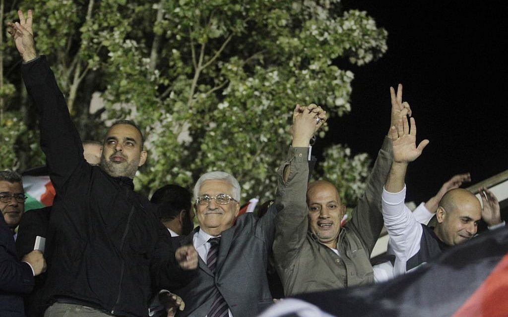 Palestinian Authority President Mahmoud Abbas, second from left, waves with released Palestinian prisoners coming from Israeli jails during celebrations at Abbas's headquarters in the West Bank town of Ramallah, October 30, 2013. (Issam Rimawi/Flash90)
